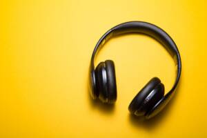 Black headphones laying on a yellow surface